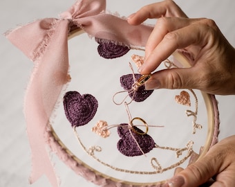 Rustic wedding ring holder with purple and pale pink crochet appliques on organza tulle on embroidery loom