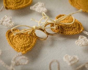 Rustic ring holder on embroidery frame with mustard yellow crochet heart appliques for fall weddings