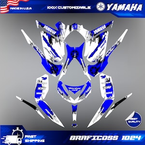 May include: A blue and white Yamaha snowmobile graphic kit with a black and white grunge design. The kit includes graphics for the front, sides, and rear of the snowmobile. The graphics feature the Yamaha logo, the words "Yamaha" and "Bridgestone", and a black and white grunge design.