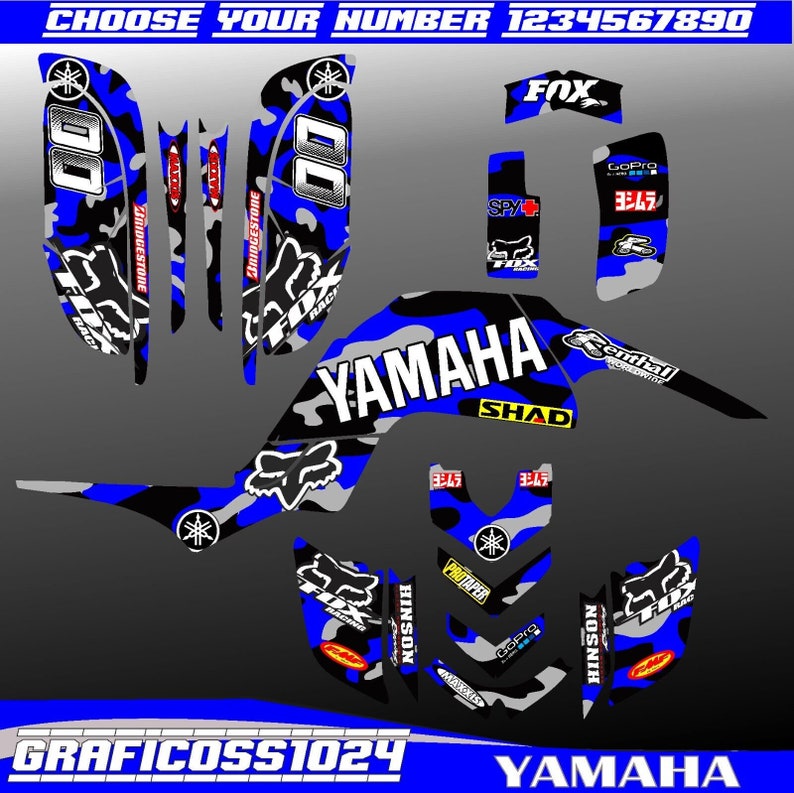 May include: A blue and grey camouflage graphic kit for a Yamaha motorcycle. The kit includes a number plate, side panels, front fender, and other decals. The kit features the Yamaha logo, Fox Racing logo, Bridgestone logo, GoPro logo, and Yoshimura logo.