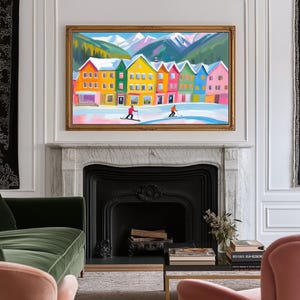 May include: A painting of a colorful row of houses in a snowy mountain village. The houses are painted in shades of yellow, green, blue, and pink. Two people are skiing in the snow in front of the houses.