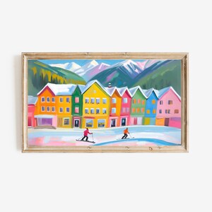 May include: A colorful painting of a row of houses in a snowy mountain village. Two skiers are in the foreground, one in red and one in orange.
