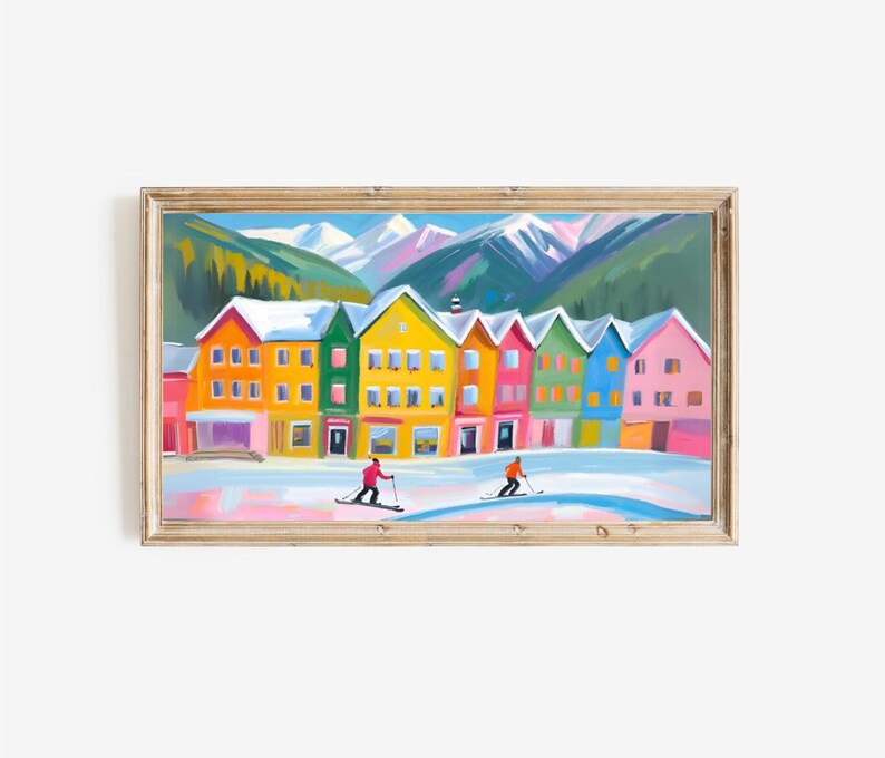 May include: A colorful painting of a row of houses in a snowy mountain village. Two skiers are in the foreground, one in red and one in orange.