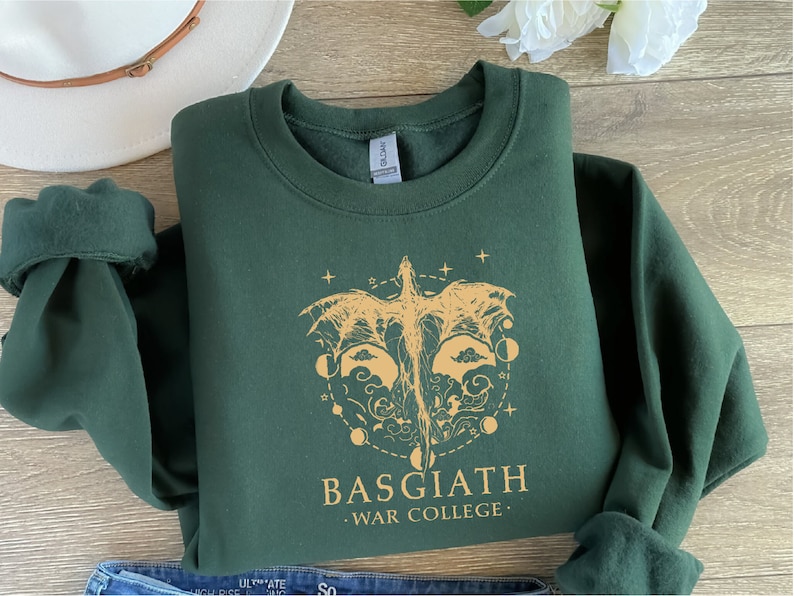 a t - shirt with a wolf head on it next to a pair of jeans
