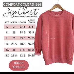 a pink sweatshirt with measurements for a women's size chart