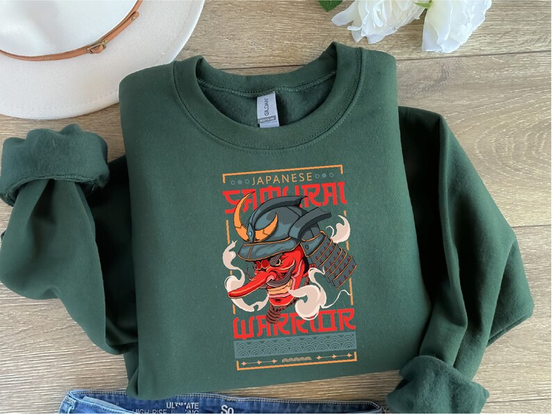 a green sweatshirt with an image of a demon on it