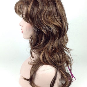 May include: A long, wavy brown wig with blonde highlights. The wig is styled in a layered, casual look.