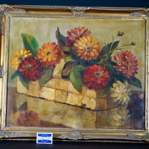 May include: A framed oil painting depicting a still life of a basket overflowing with vibrant red, orange, and yellow flowers. The flowers are arranged in a rustic woven basket, set against a warm, golden background.