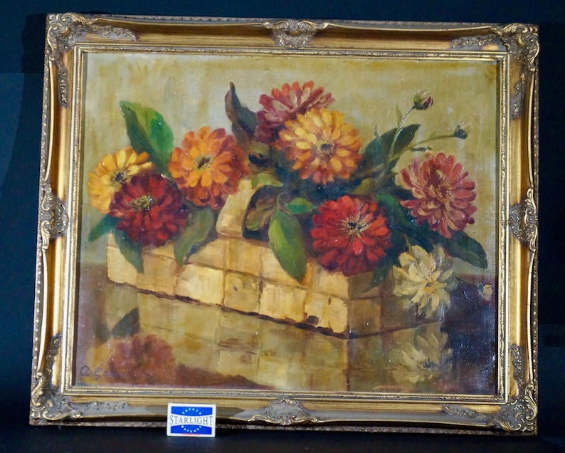 May include: A framed oil painting depicting a still life of a basket overflowing with vibrant red, orange, and yellow flowers. The flowers are arranged in a rustic woven basket, set against a warm, golden background.