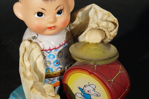 Tin toy drumming kid