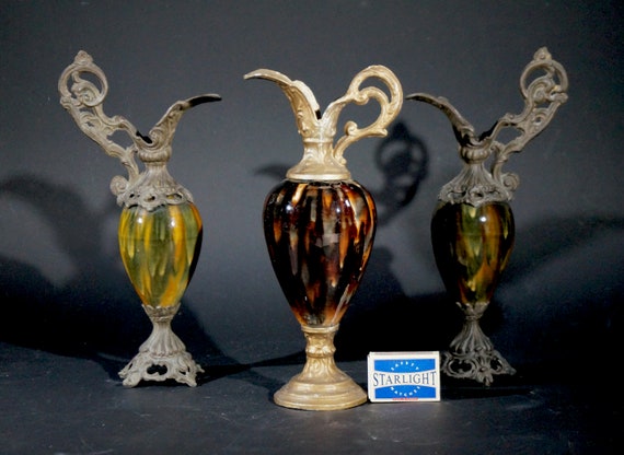 Three metal and porcelain vases
