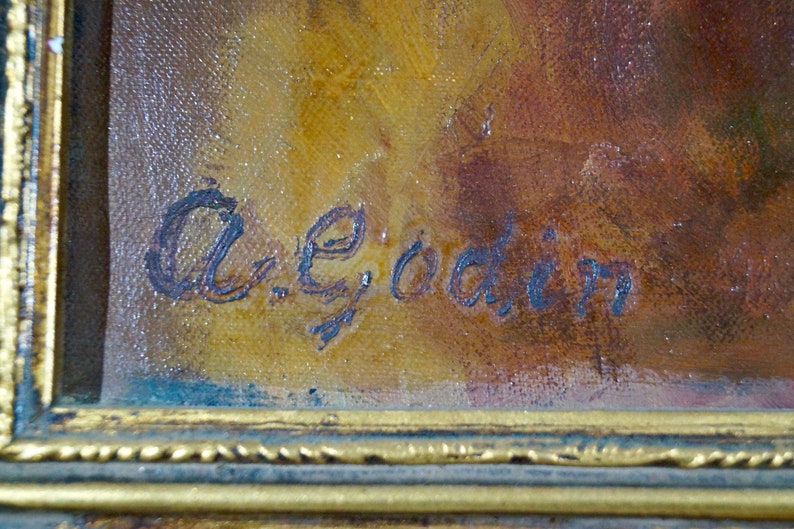 May include: A close-up of a painting's signature, written in blue ink on a canvas with a brown and yellow background. The signature reads "A.E. Goadin".
