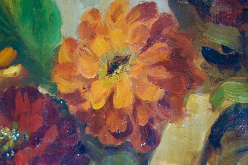 May include: A close-up of a painting featuring a vibrant orange flower with red and yellow hues. The flower is surrounded by green leaves and other flowers in shades of red and brown.