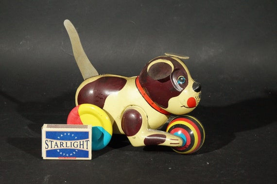 Tin toy brown dog on wheels