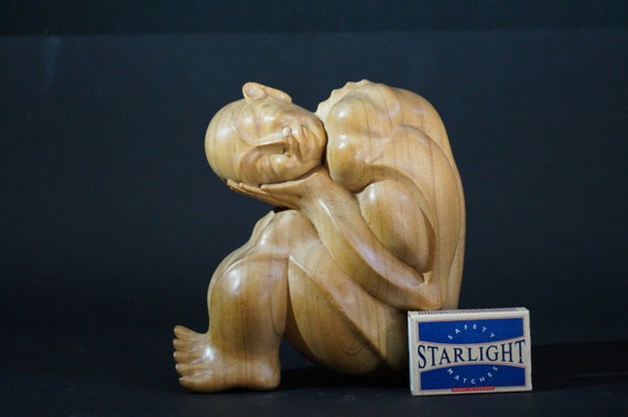 Woodcarving resting man
