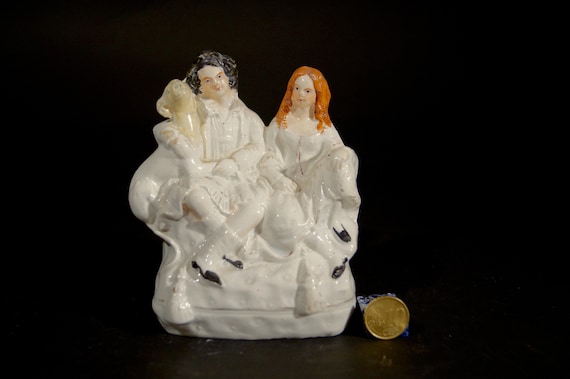 Staffordshire white figurine of a couple. Ceramic, Collectable, hand painted.
