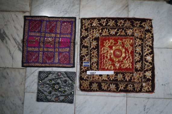 Three hand embroidered textiles