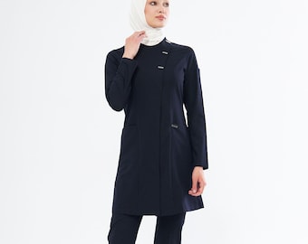May include: A black pantsuit with a long-sleeved jacket and a white headscarf. The jacket has a button closure and a pocket on each side. The pants have a straight leg.