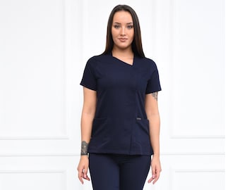 May include: A navy blue scrub top with a diagonal zipper and a matching pair of pants. The top has a short sleeve and a v-neck collar.