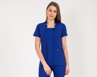 May include: A royal blue medical scrub set with a collared top and matching pants. The top has a square neckline and short sleeves. The pants have a straight leg.