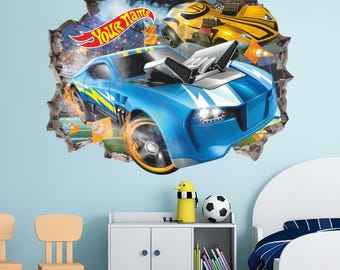 May include: A wall decal featuring a blue race car bursting through a wall, with a yellow race car in the background. The decal includes the text "Your Name" on a banner. The cars have flames and are surrounded by orange cones.