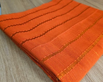 New Nigeria  Orange Gele /ipele in Aso Oke. ( Price Per piece). Matching Cap/fila is available for Men.