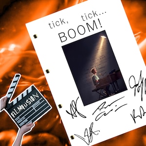 May include: A white script page with the words "tick, tick... BOOM!" printed in black. A black and white photo of a person playing a piano is in the center of the page. The page is signed by multiple people.