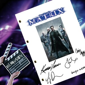 May include: A white script page from the film "The Matrix" with signatures from the cast and crew. The signatures include "Carrie-Anne Moss", "Keanu Reeves", "Lana Wachowski", and "Hugo Weaving". The page features a black and white photograph of the main characters from the film.
