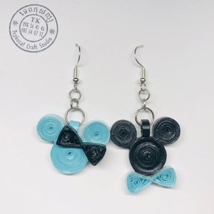 May include: A pair of blue and black paper quilled earrings shaped like Mickey Mouse. The earrings are on a silver hook.