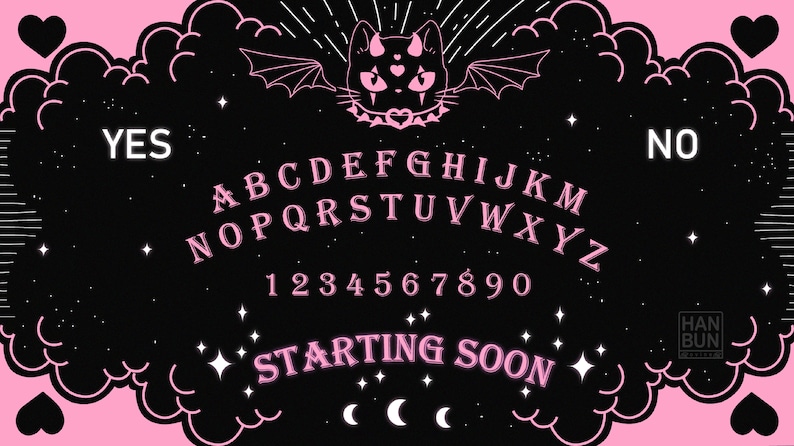 May include: A black and pink Ouija board with a black cat with bat wings and a heart on its collar. The board has the letters A-Z, numbers 1-9 and 0, the words "YES" and "NO", and the text "STARTING SOON".