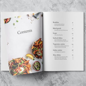 Open spread mockup showing the contents of the cookbook template with a nice fresh picture of vegetables in a bowl