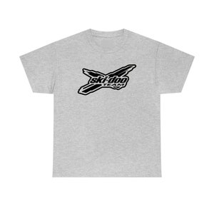 May include: A grey t-shirt featuring a black Ski-Doo Team logo. The logo is a stylised X with the words "Ski-Doo Team" inside.