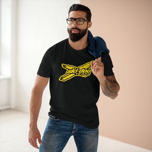 May include: A black t-shirt featuring a yellow Ski-Doo Team logo. The logo depicts a stylised ski with the words "Ski-Doo Team" in black text.