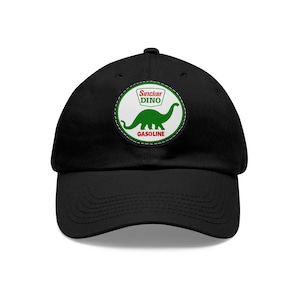 May include: Black baseball cap with a white and green patch featuring a dinosaur and the text "Sinclair Dino Gasoline".