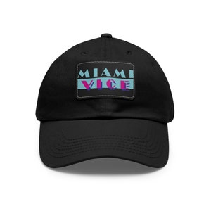 May include: A black baseball cap with a patch that says "Miami Vice" in a retro 80s style font with blue, pink, and purple colors.