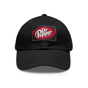 May include: Black baseball cap with a red and white Dr Pepper logo patch. The patch has the text "Dr Pepper Est. 1885".