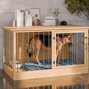 May include: A wooden dog crate with a light finish, featuring metal bars and a door. A German Shepherd dog stands inside on a blue mat. The crate has a flat top with books and decor.