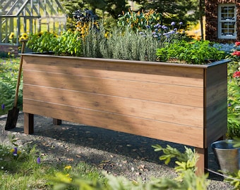 May include: A wooden raised garden bed with a brown finish and black metal legs. The bed is filled with various plants and flowers, including herbs and lavender.