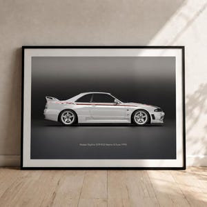 May include: A framed wall art print featuring a side profile of a white Nissan Skyline GTR R33 Nismo S-Tune 1995 sports car. The vehicle is set against a dark gray background with the text Nissan Skyline GTR R33 Nismo S-Tune 1995 printed below.