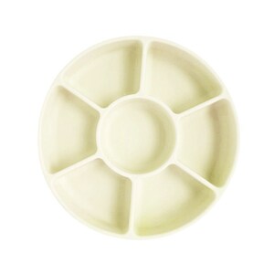 May include: A round, off-white ceramic dish with seven compartments. The dish has a central circular compartment and six smaller compartments around the edge.