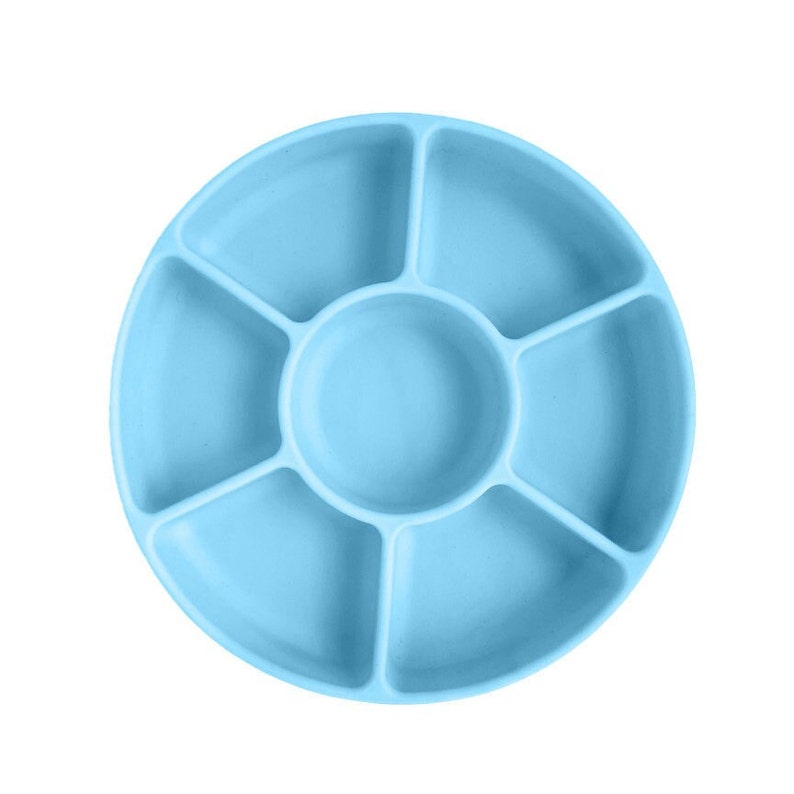 May include: A light blue silicone divided plate with six sections. The plate is round and has a raised edge.