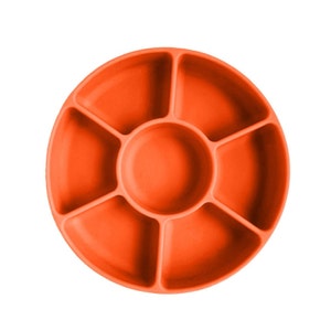 May include: Orange silicone divided plate with six sections. The plate is designed for feeding babies and toddlers.