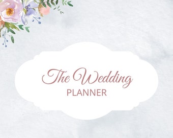 May include: A wedding planner with a watercolor design. The cover features the text "The Wedding Planner" in a decorative font, set against a white cloud-shaped background. Floral arrangements in pink, purple, and green adorn the corners.