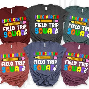 May include: Six different colored t-shirts with the text "Kindergarten Field Trip Squad" and a colorful pencil graphic.