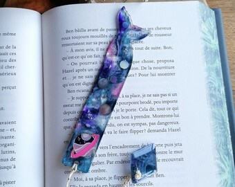 Handmade bookmark in epoxy resin on the theme of the galaxy/universe.