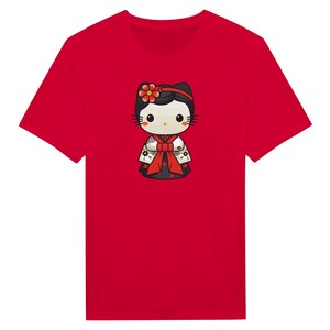 May include: A red t-shirt featuring a cartoon character in a traditional Japanese kimono. The character has a black bow, flower, and black hair. The kimono is black, white, and red. The t-shirt is a solid red color.
