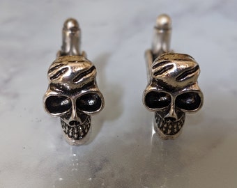 Gemelos de cráneo de plata