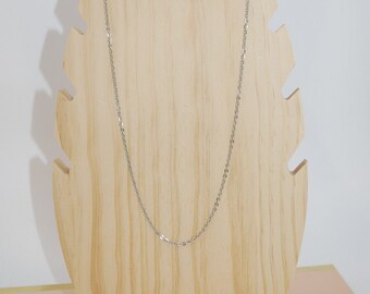 May include: A silver chain necklace displayed on a wooden jewelry stand.