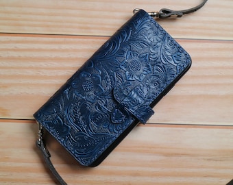 May include: A blue leather phone case with a floral embossed design and a strap.