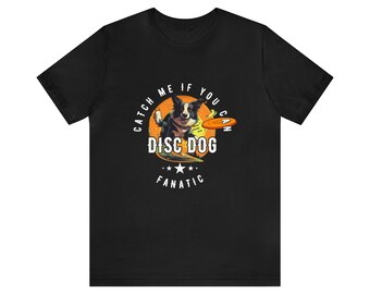 May include: Black t-shirt with a white circle graphic featuring a black and white dog catching a flying disc. The text inside the circle reads "Catch Me If You Can Disc Dog Fanatic".